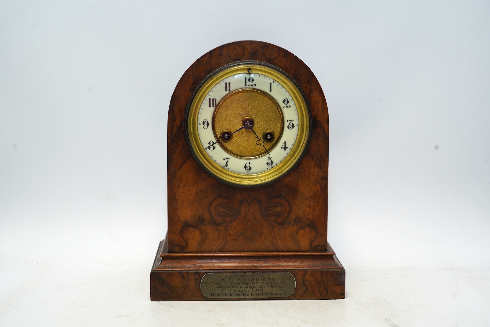 An Edwardian mantel clock with Arabic dial and applied plaque, 25cm high. Condition - fair to good, some cracking to the wood